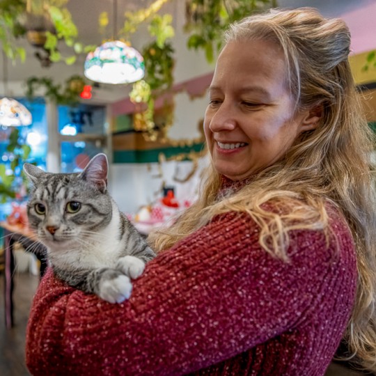 Paw Patrol Dayton's September 2025 Volunteer of the month, Ricki, with a cat.